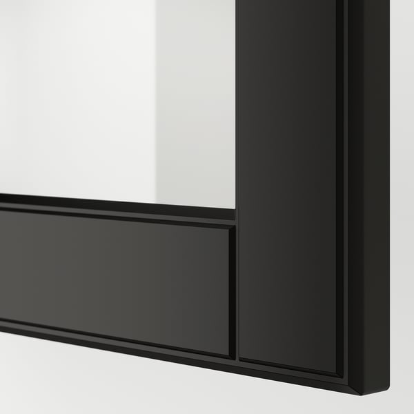 Black framed glass door with beveled edges, part of modern kitchen system. High-quality design, sturdy construction.