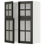 Modern kitchen unit with black glass doors and white shelves.
