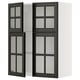 Modern kitchen unit with black glass doors and white shelves.