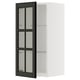 A white METOD wall cabinet with black bodbyn glass doors featuring beveled edges. The cabinet has an adjustable shelf and sturdy construction.