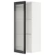 Displays a white METOD kitchen cabinet with a black hejsta glass door, featuring a reeded glass design and a sleek metal frame.