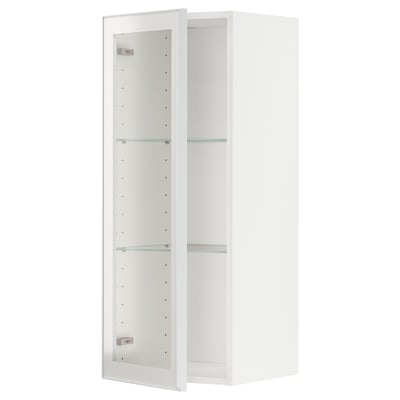 A white METOD kitchen cabinet with glass shelves and metal-framed doors. The cabinet has an adjustable shelf and a modern design.