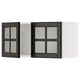 Black and white kitchen cabinets with glass doors. One door is open, revealing inner shelves. The design is modern and sleek.