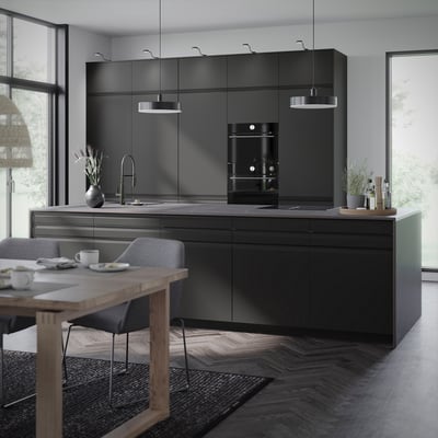 Modern kitchen with black METOD cabinets, sleek handles, hanging lights, wooden table, and grey rug.