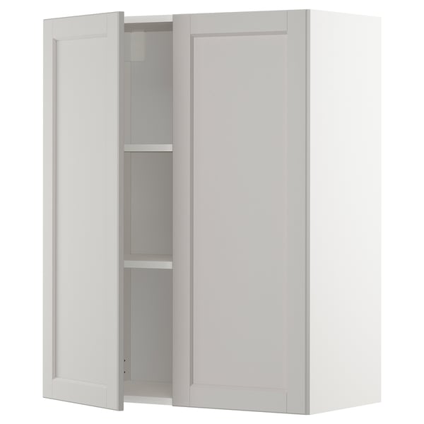 Light grey METOD kitchen cabinet with beveled edges and two open doors.