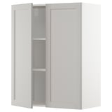 Light grey METOD kitchen cabinet with beveled edges and two open doors.