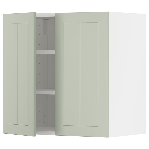 A light green METOD kitchen cabinet with two doors and adjustable shelves, set against a white background.