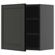 Dark grey kitchen cabinet with single door open, revealing adjustable shelves.