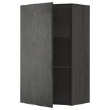 A black METOD wall cabinet with a dark grey concrete effect door, featuring an adjustable shelf inside.