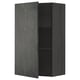 A black METOD wall cabinet with a dark grey concrete effect door, featuring an adjustable shelf inside.