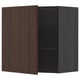 A METOD dark brown kitchen cabinet with a wooden door partially open, revealing two shelves inside.