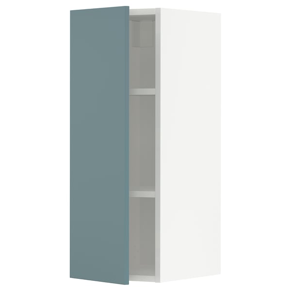 Turquoise METOD kitchen cabinet with white shelves.