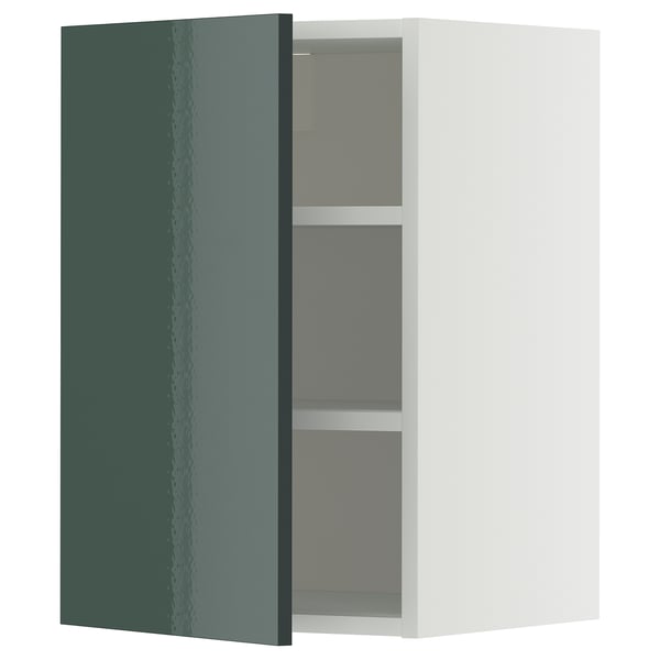 A greenish-gray METOD kitchen cabinet with a high-gloss finish, a white frame, and two adjustable shelves.
