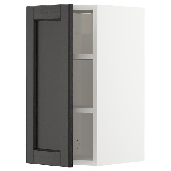 A black stained METOD kitchen cabinet with a beveled door and shelves.