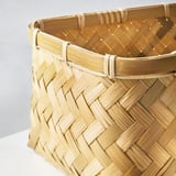 Handwoven bamboo basket, finely crafted, showcasing tight, intricate weave, sturdy handles, smooth finish.