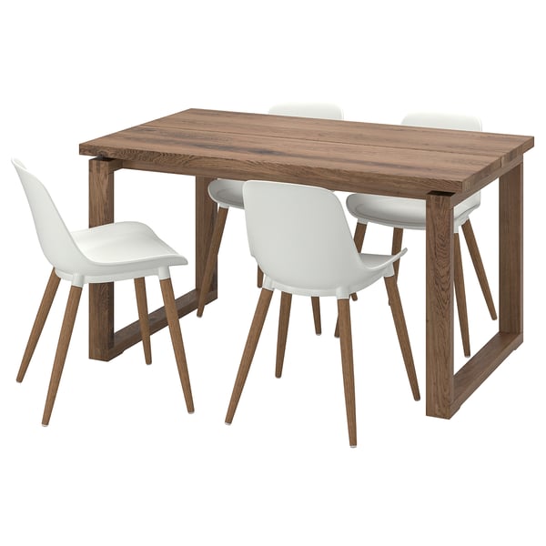 Brown wooden dining table and four white plastic chairs. Modern design with angled legs.