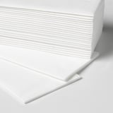 Stack of white cloth-like paper napkins neatly arranged, showing texture and quality.