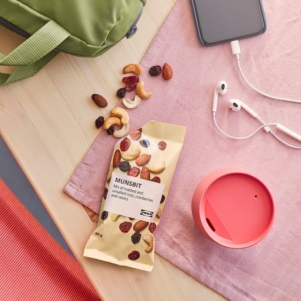 IKEA MUNSBIT mix spills on wood with cloth, cup, earphones, phone.