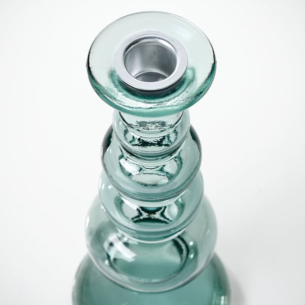 Glass candlestick with recycled texture; metallic interior, reflective surface.