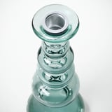 Glass candlestick with recycled texture; metallic interior, reflective surface.