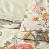 Floral duvet cover with zipper, showcasing intricate patterns in shades of orange, red, and green against a beige background.