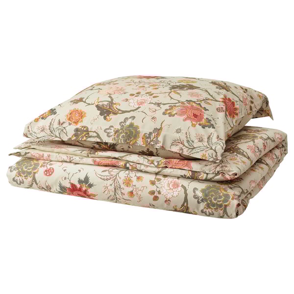Floral bedding set, cream with multicolor flowers, folded neatly, zipper detail.