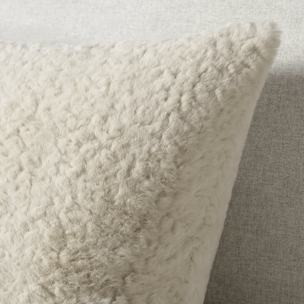 Soft, plush cushion; beige, recycled polyester; fluffy, inviting texture.