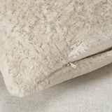 Close-up of soft, plush beige pillow cover with visible zipper, highlighting its supersoft texture and quality.