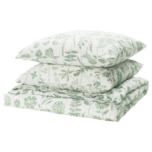 A NÅLBJÖRNBÄR bedding set in green and white with floral print, made from cotton and viscose.