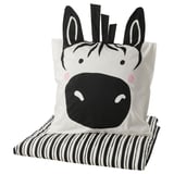 Zebra-themed pillow and blanket: black & white stripes, soft fabric, playful design.