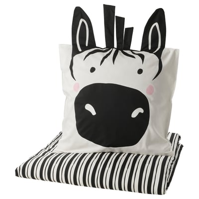 Zebra-themed pillow and blanket: black & white stripes, soft fabric, playful design.