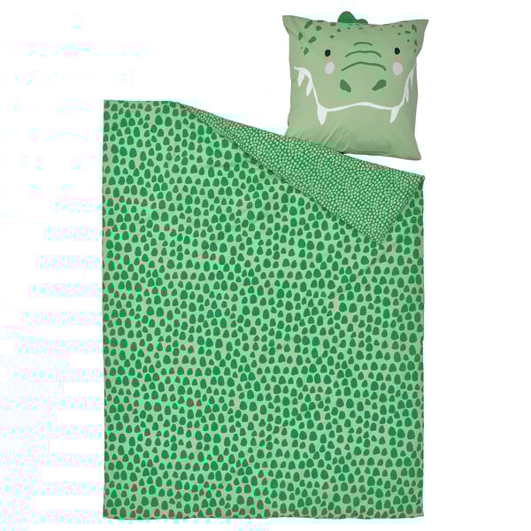 Green crocodile-themed duvet set. Green spotted blanket and matching pillow with smiley crocodile face.