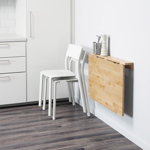 Foldable wall table, space-saving for small kitchens. Seats 2, folds away, shown with white stacked chairs.