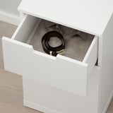 Open white NORDLI drawer revealing a belts organizer inside.
