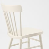 White spindle chair with rounded edges; sturdy, clean-lined, and comfortable.