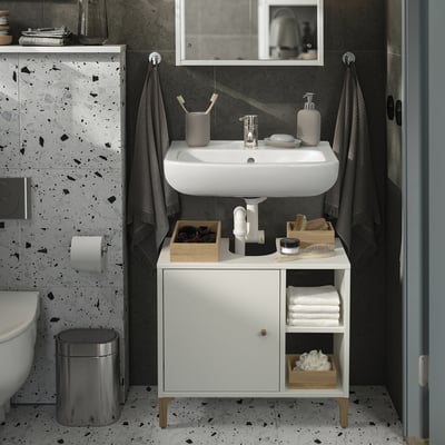 Modern bathroom with white NORSÄLVEN cabinet under sink, black/white walls. Functional storage, towel hooks, wall-mounted for stability.