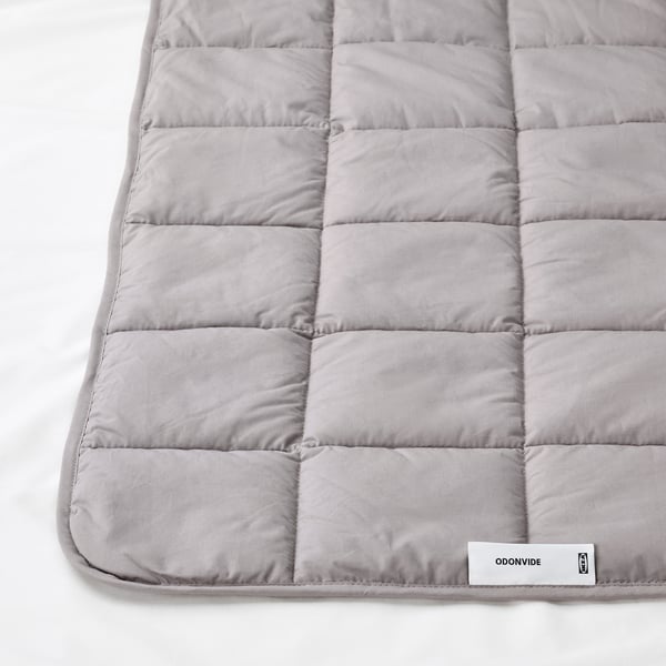 Light gray weighted blanket with box-stitch, branded ODONVIDE, on white surface.