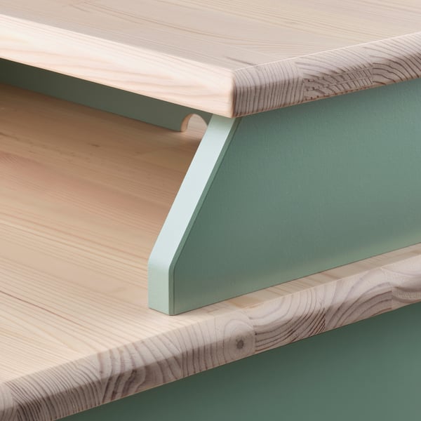 Scandinavian-style bedside table with natural wood top and green metal frame, showcasing craftsmanship and durability.