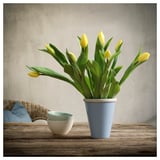 Blue ceramic vase with yellow tulips on wooden table. Rustic, simple design.