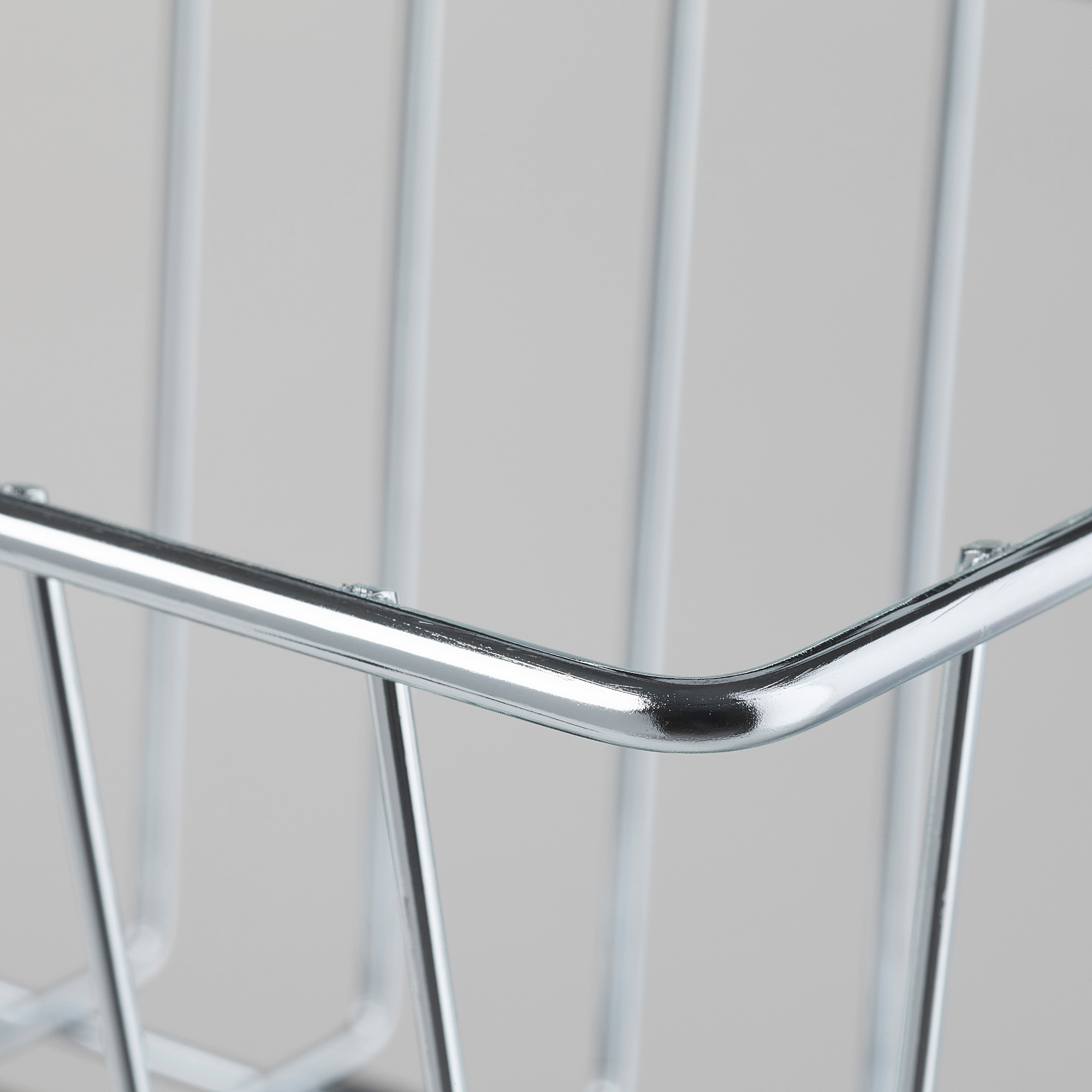 Close-up of a shiny, silver wire basket corner joint, showcasing sturdy metal construction and clean welds.