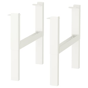Displays two white PÅHL desk legs, each with adjustable height knobs and cable holders for organized cords.