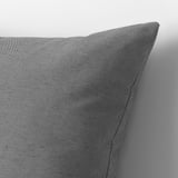 Gray cushion against gray background. High-quality fabric, recycled materials visible in texture.