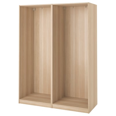 An ikea PAX wardrobe frame, light oak, rectangular, with open spaces and wooden panels.