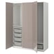 An open beige PAX wardrobe with shelves, drawers, and baskets.