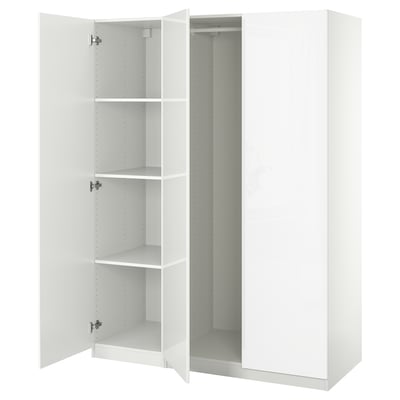 White PAX wardrobe open, showing empty shelves, modern design.