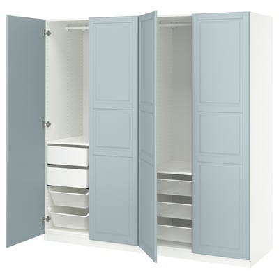 An open blue-gray ikea PAX wardrobe with shelves and mesh storage.