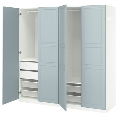 An open light blue ikea PAX wardrobe with shelves and drawers.