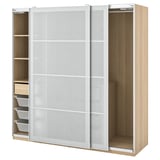 Modern light wooden wardrobe with frosted glass doors, open on one side, displaying shelves and storage baskets inside.