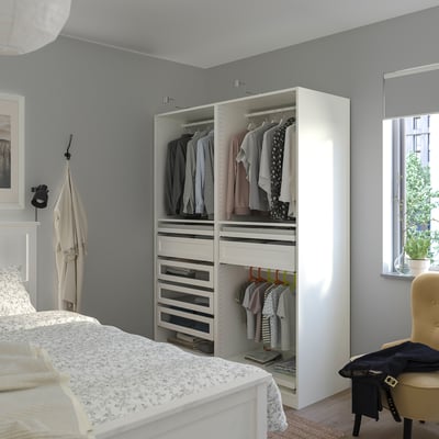 Modern grey bedroom with large white PAX wardrobe, open sections, and a bed with white lace cover.