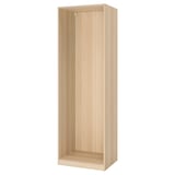 A tall, light wood-colored PAX wardrobe frame with a minimalist design.